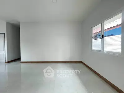 Spacious empty room with large window and glossy tiled floor, perfect for customization.