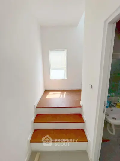 Bright stairway with natural light and adjacent bathroom in modern home