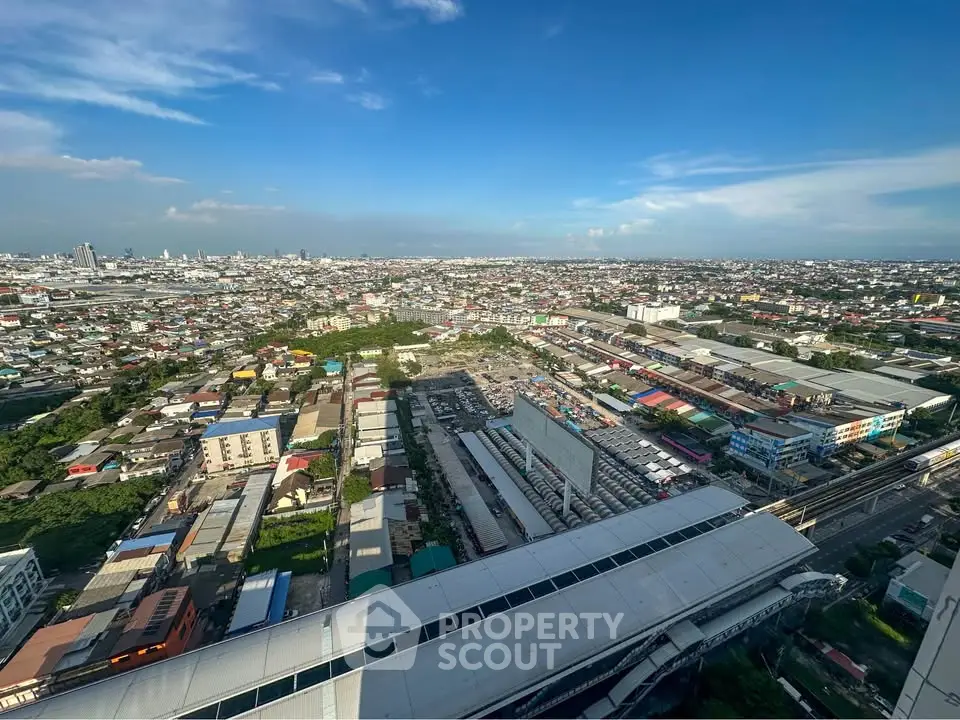 Stunning aerial view of urban landscape with sprawling cityscape and clear blue sky.