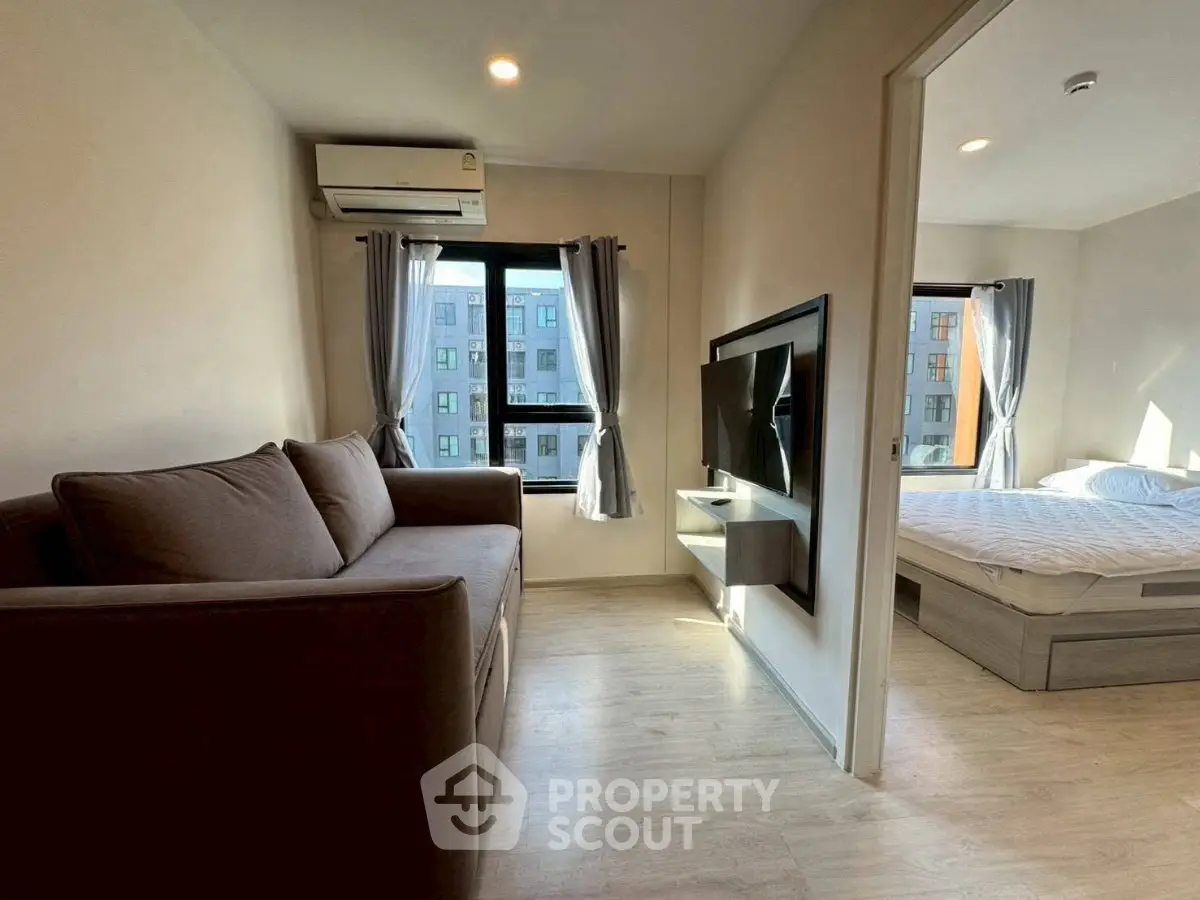 Modern apartment with cozy living room and bedroom, featuring natural light and stylish furnishings.