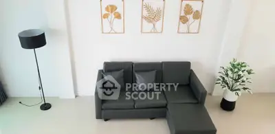 Modern living room with sleek black sofa and stylish decor