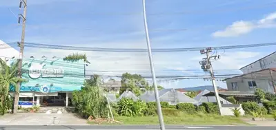 Charming suburban property with lush greenery and clear blue skies, ideal for serene living.