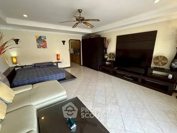 Spacious living room with modern decor and large TV unit