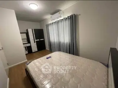 Spacious bedroom with modern furnishings and ample natural light, perfect for relaxation and comfort.