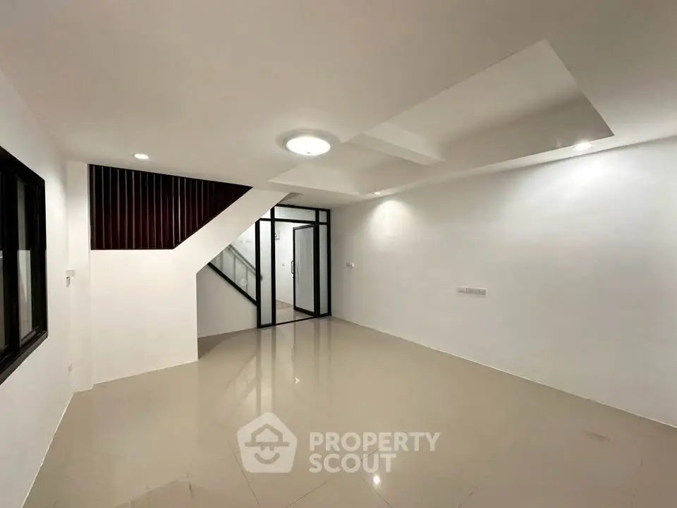 Spacious modern living room with sleek design and ample natural light