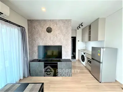 Modern living room with stylish decor and integrated kitchen appliances