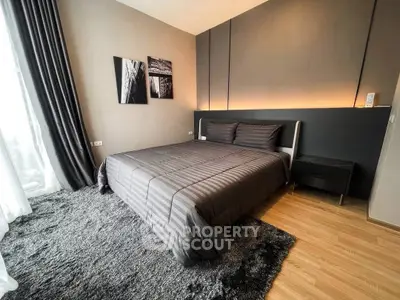 Modern bedroom with stylish decor and cozy ambiance in a luxury apartment.