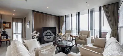 Luxurious modern living room with panoramic city views and elegant furnishings.