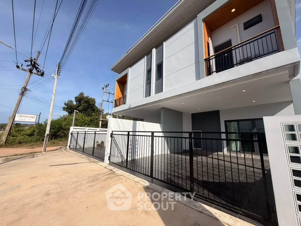 Modern two-story house with sleek design and spacious balcony in a serene neighborhood.