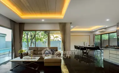Luxurious open-plan living room with pool view and modern decor