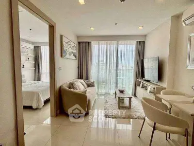 Modern living room with open layout and large windows in a stylish apartment.