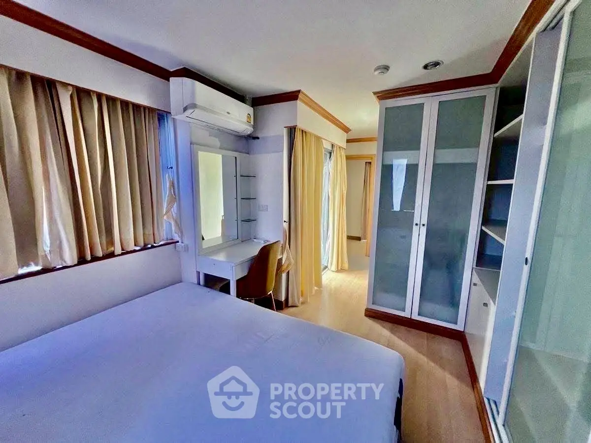 Spacious bedroom with modern furnishings and ample natural light