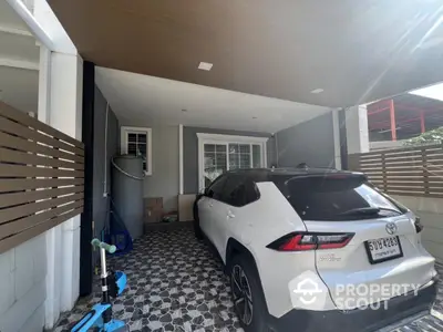 Modern home carport with stylish flooring and sleek vehicle parked