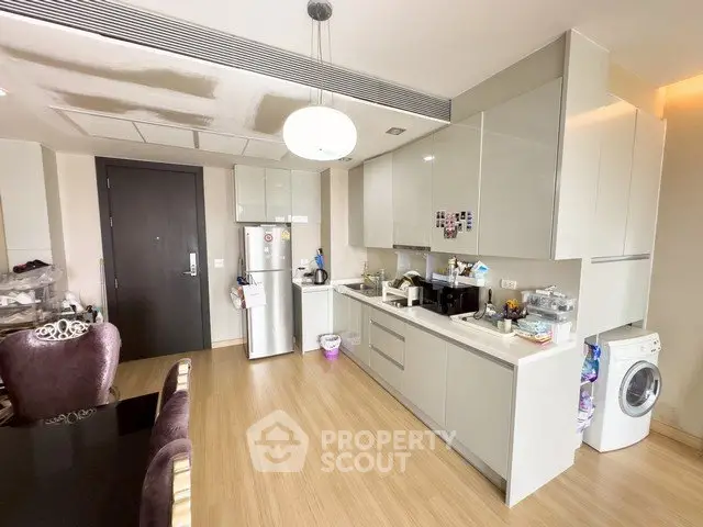 Modern kitchen with sleek cabinetry and integrated appliances in a stylish apartment.