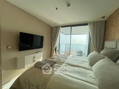 Luxurious bedroom with stunning ocean view and private balcony access