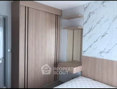 Modern bedroom with sleek wardrobe and stylish marble accent wall
