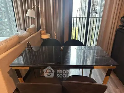 Modern living room with elegant marble table and city view balcony.