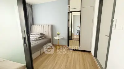 Modern bedroom with stylish decor and mirrored wardrobe in a cozy apartment.