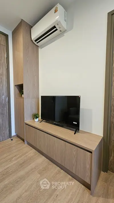 Modern living room with sleek TV unit and air conditioning