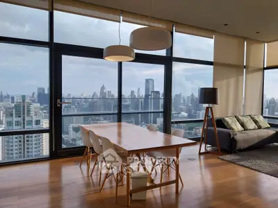 Stunning high-rise living room with panoramic city views and modern furnishings.