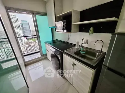 Modern kitchen with city view, featuring sleek appliances and ample storage space.