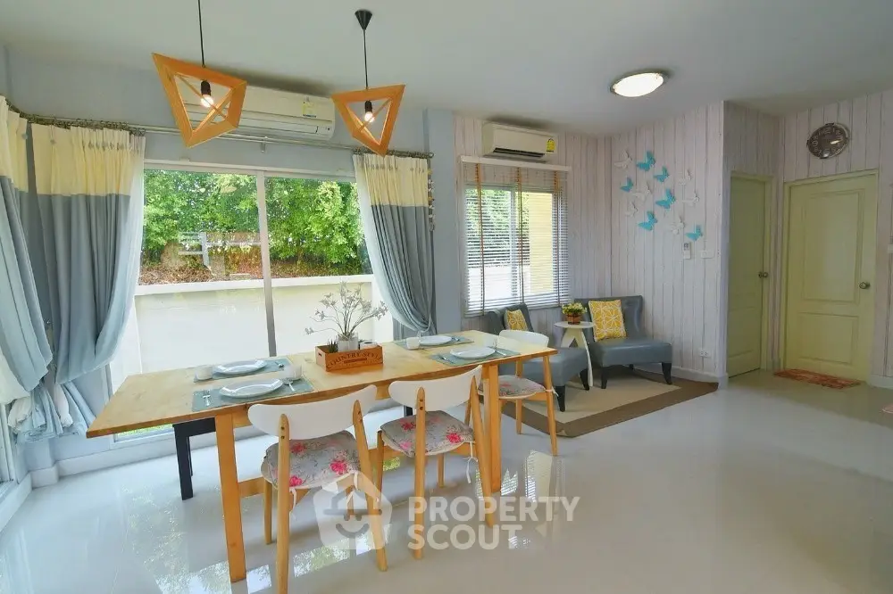 Charming dining area with modern decor and garden view, perfect for family gatherings.