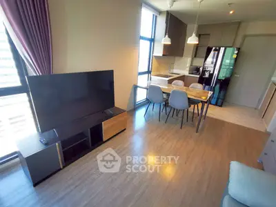 Modern open-plan living room with dining area and sleek kitchen