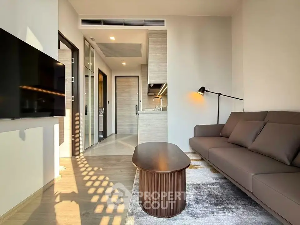 Modern living room with sleek furniture and open kitchen layout, perfect for urban living.