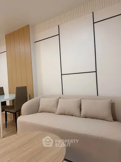 Modern living room with stylish beige sofa and elegant dining area
