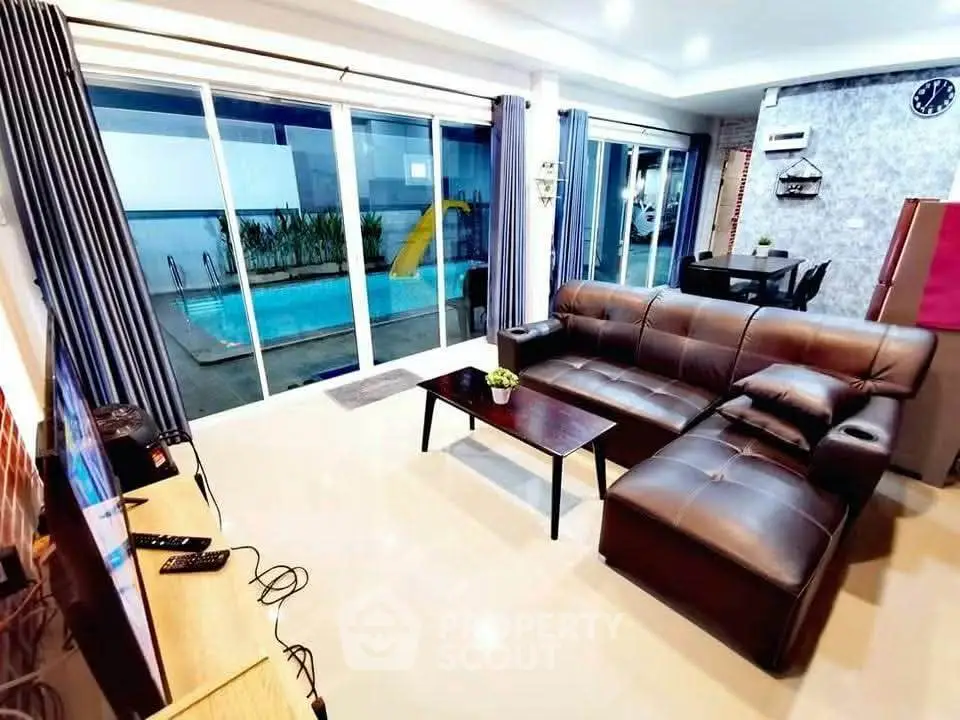 Luxurious living room with pool view and modern leather sofa