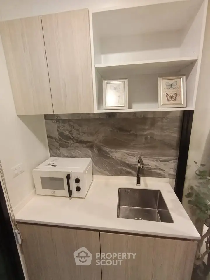 Modern compact kitchen with sleek cabinetry and stainless steel sink