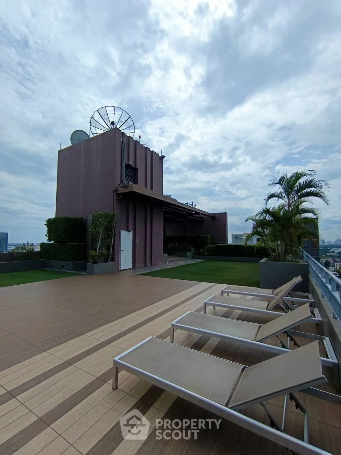 Stunning rooftop terrace with lounge chairs and city views