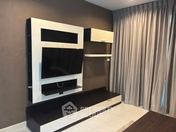 Modern living room with sleek TV unit and elegant curtains