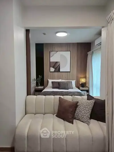 Modern bedroom with stylish decor and cozy seating area, perfect for relaxation and comfort.