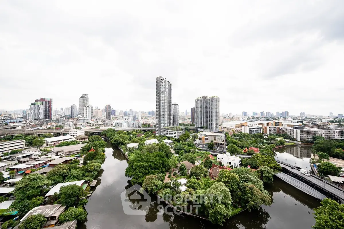 Stunning cityscape view with lush greenery and modern high-rise buildings.