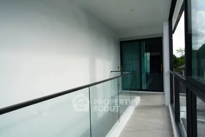 Modern balcony with glass railing and scenic view in luxury property
