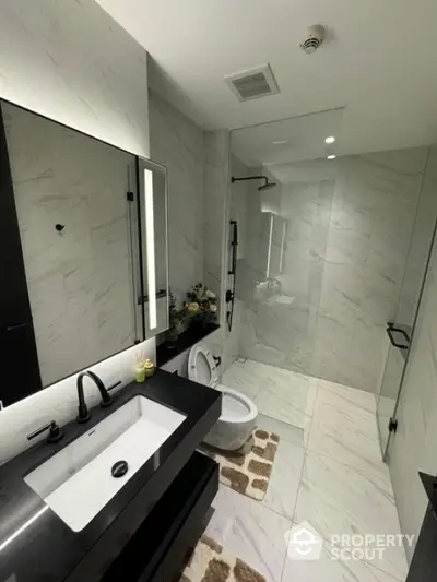 Modern bathroom with sleek black fixtures and elegant marble tiles