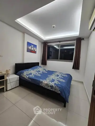 Modern bedroom with stylish ceiling lights and large window in a contemporary apartment.