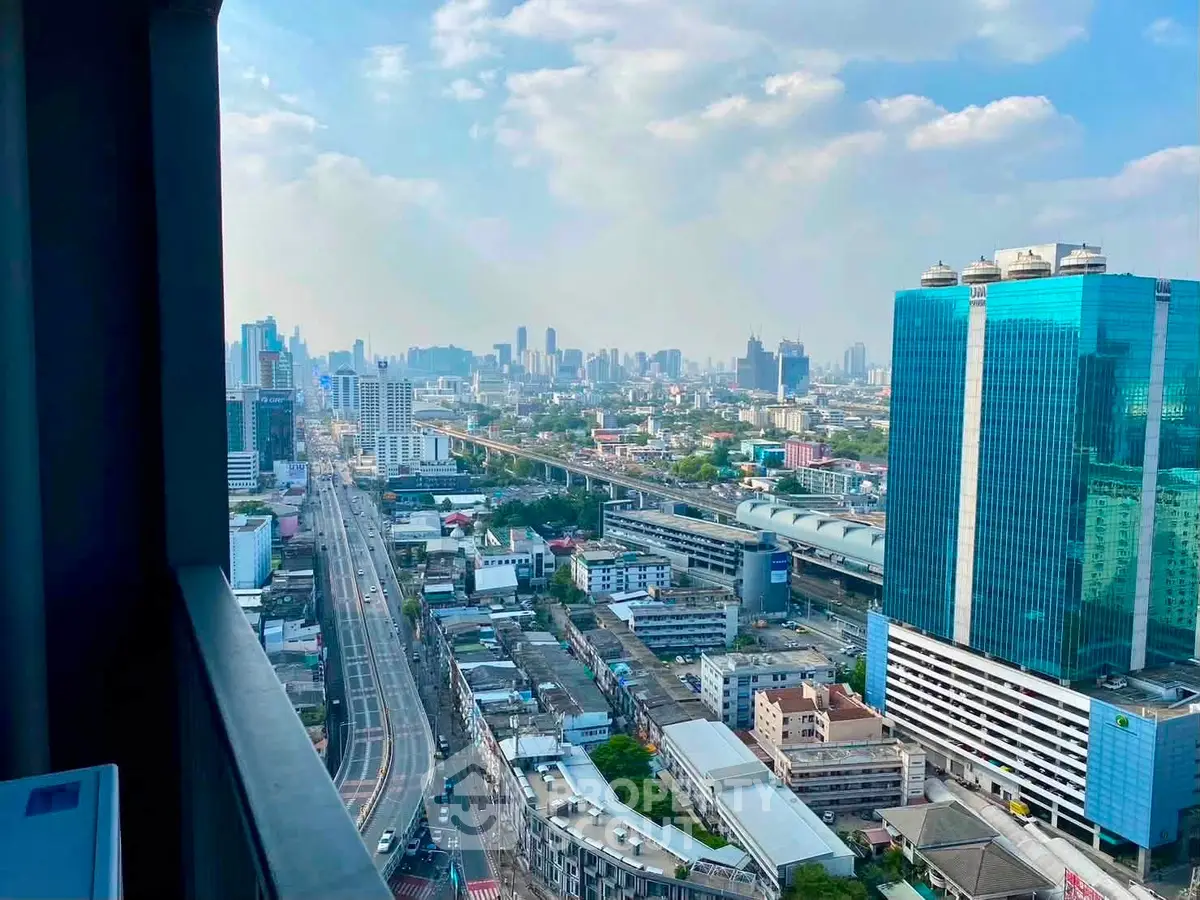 Stunning cityscape view from high-rise balcony with modern skyscrapers and urban skyline.