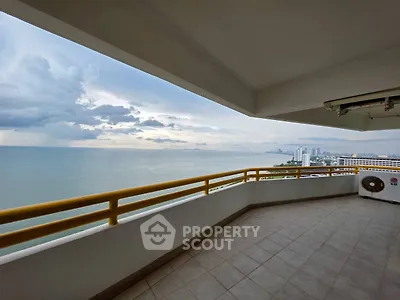 Spacious balcony with stunning ocean view in high-rise building.