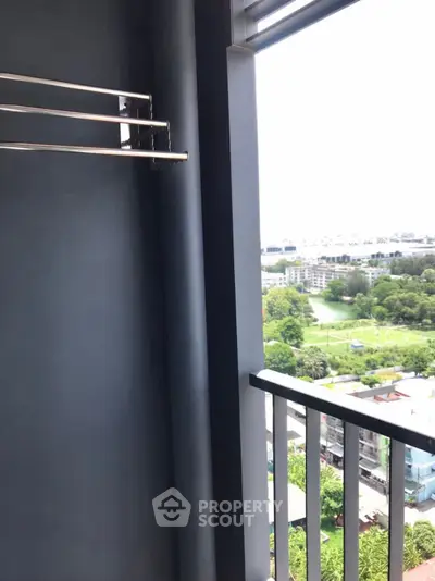 Stunning balcony view overlooking lush greenery and cityscape, perfect for relaxation and enjoying the outdoors.