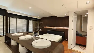 Modern bedroom with sleek design and integrated workspace, featuring wooden accents and ambient lighting.