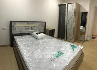 Modern bedroom with stylish bed and wardrobe in a cozy apartment.