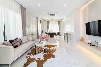 Luxurious modern living room with elegant decor and open dining area, featuring marble floors and stylish furniture.