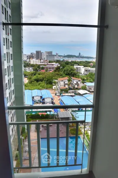 Stunning high-rise balcony view overlooking cityscape and pool