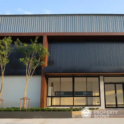 Modern commercial building exterior with sleek design and large glass windows.