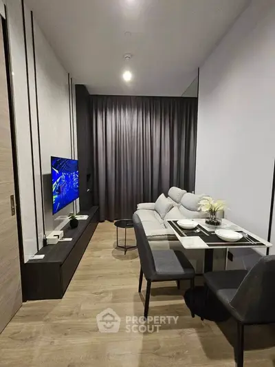 Modern living room with sleek furniture and dining area, featuring a cozy ambiance and stylish decor.