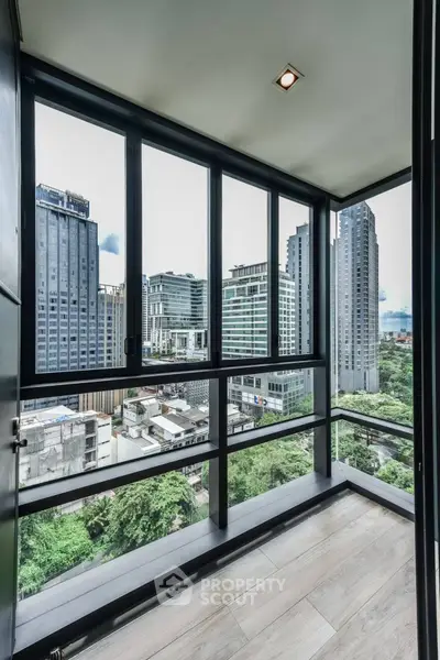 Stunning urban balcony view with floor-to-ceiling windows in a modern high-rise building.