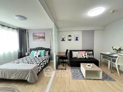 Modern studio apartment with stylish decor and open layout, featuring a cozy bed and chic living area.