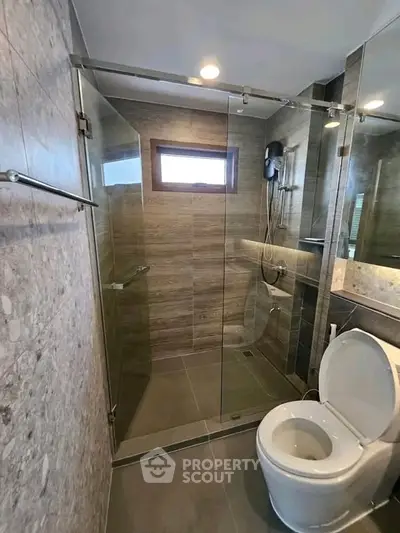 Modern bathroom with glass shower enclosure and sleek tile design